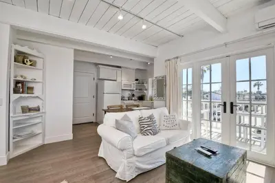 a living room with a white couch and a table at 3690 Carlsbad Boulevard - Unit C in Carlsbad