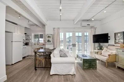 a living room with a couch and a table at 3690 Carlsbad Boulevard - Unit C in Carlsbad