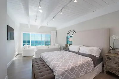a bedroom with a large bed and a large window at 3690 Carlsbad Boulevard - Unit B in Carlsbad