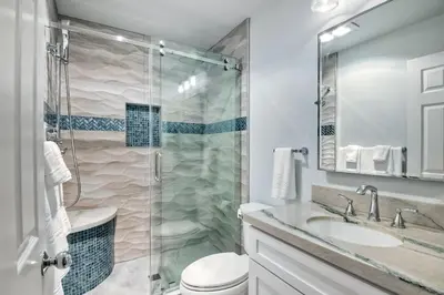 a bathroom with a shower and a toilet and a sink at 400 N Pacific - Unit 203 in Oceanside