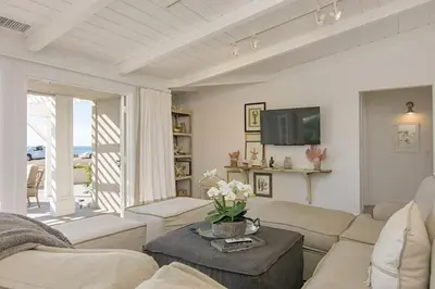 a living room with a couch and a table at 3690 Carlsbad Boulevard - Unit A in Carlsbad