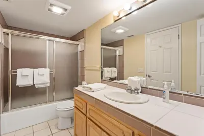 a bathroom with a sink and a toilet and a mirror at 1317 S Pacific - Entire Home in Oceanside