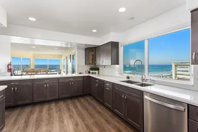 a large kitchen with a view of the ocean at 1317 S Pacific - Entire Home in Oceanside