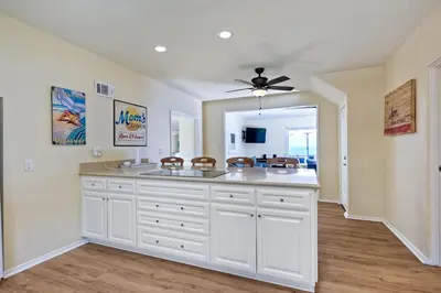 a kitchen with white cabinets and a ceiling fan at 1745 S Pacific in Oceanside