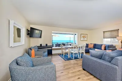 a living room with a couch and chairs and a table at 1745 S Pacific in Oceanside
