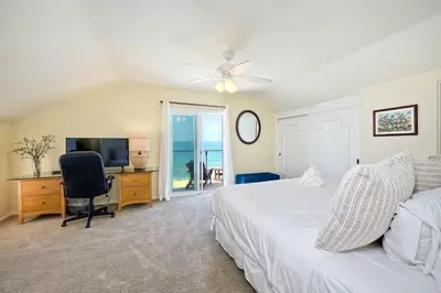 a bedroom with a bed and a desk with a television at 1745 S Pacific in Oceanside