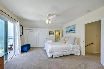 a bedroom with a bed and a ceiling fan at 1745 S Pacific in Oceanside