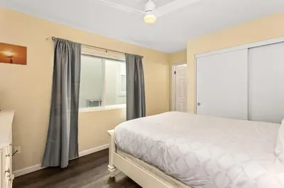 a bedroom with a bed and a window at 1317 S Pacific - Unit C in Oceanside