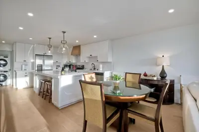 a kitchen and living room with a table and chairs at 597 S Sierra Avenue - Unit 68 in Solana Beach