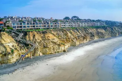 a view of a beach with buildings on a cliff at 597 S Sierra Avenue - Unit 68 in Solana Beach