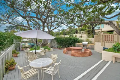 a patio with a table and chairs and an umbrella at 597 S Sierra Avenue - Unit 68 in Solana Beach