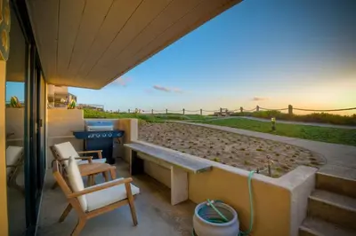 a patio with a bench and a table and chairs at 597 S Sierra Avenue - Unit 68 in Solana Beach