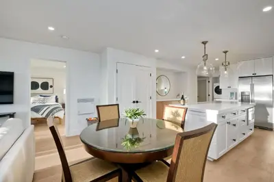 a kitchen and dining room with a glass table and chairs at 597 S Sierra Avenue - Unit 68 in Solana Beach