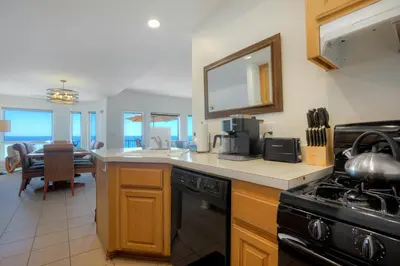 a kitchen with a sink and a stove top oven at 2751 Ocean Street in Carlsbad