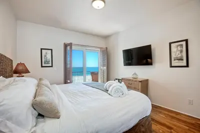 a bedroom with two beds and a flat screen tv at 2751 Ocean Street in Carlsbad