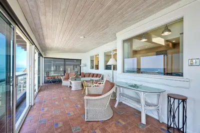 a room with a patio with a table and chairs at 1923 S Pacific in Oceanside