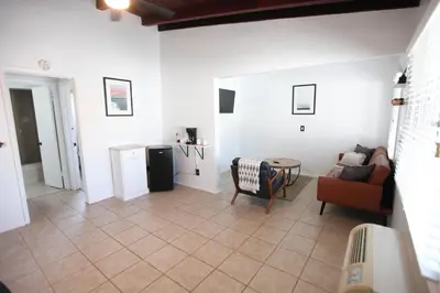 a living room with a couch and a table at West Coast Surf and Stay in San Clemente