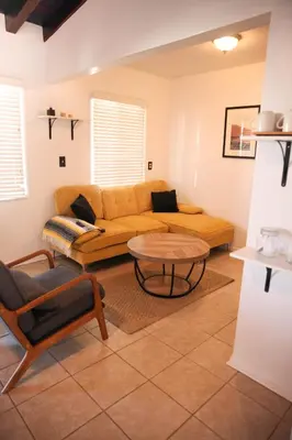 a living room with a couch and a table at West Coast Surf and Stay in San Clemente