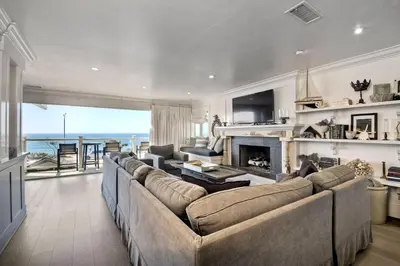 a living room with a couch and a fireplace at 3636 Carlsbad Blvd - Upper in Carlsbad