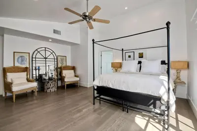 a bedroom with a bed and a ceiling fan at 3636 Carlsbad Blvd - Upper in Carlsbad