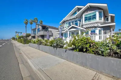 a white house on the side of a street at 3636 Carlsbad Blvd - Upper in Carlsbad