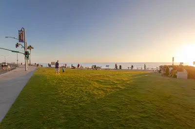 a person walking on a beach with the ocean in the background at 3636 Carlsbad Blvd - Upper in Carlsbad