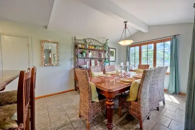 a dining room with a wooden table and chairs at 5051 Shore Drive in Carlsbad