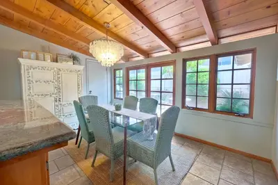 a dining room with a glass table and chairs at 5051 Shore Drive in Carlsbad