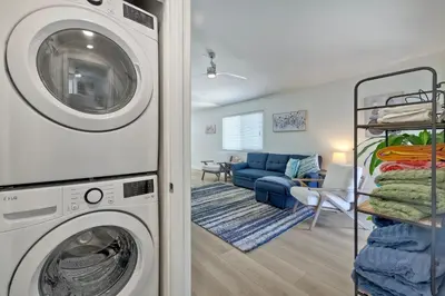 a laundry room with a washer and a couch at 1128 Tait Street Unit D in Oceanside