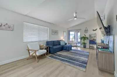 a living room with a blue couch and a table at 1128 Tait Street Unit D in Oceanside