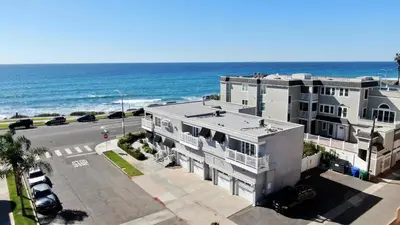 an aerial view of a building next to the ocean at 3690 Carlsbad Boulevard - Entire Home in Carlsbad