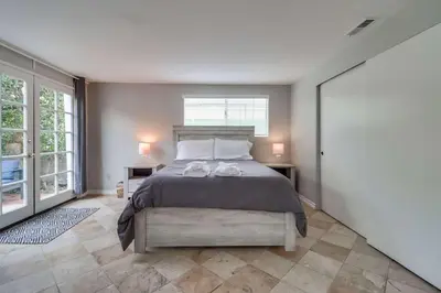 a bedroom with a bed with two shoes on it at Steps to ocean & bay large patio 4 parking spots in San Diego