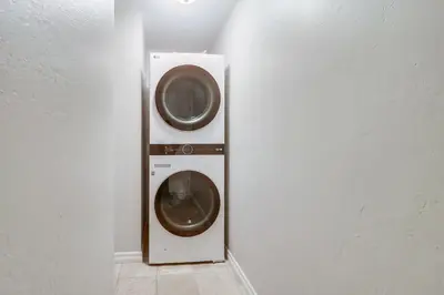 a washer and dryer in a corner of a room at Steps to ocean & bay large patio 4 parking spots in San Diego