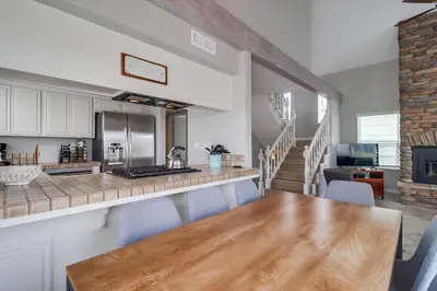 a kitchen and dining room with a wooden table at Steps to ocean & bay large patio 4 parking spots in San Diego