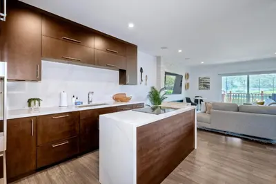 a kitchen with a sink and a living room at 2003 Costa Del Mar Road - Unit 660 in Carlsbad