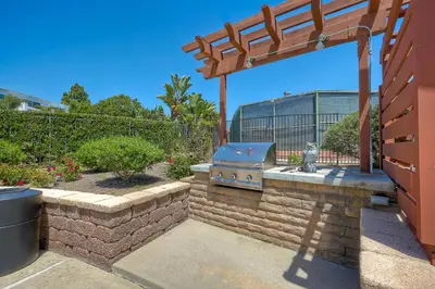 a grill sitting on a brick wall in a yard at 2003 Costa Del Mar Road - Unit 660 in Carlsbad