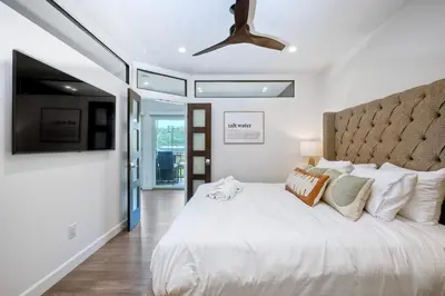 a bedroom with a large white bed and a ceiling at 2003 Costa Del Mar Road - Unit 660 in Carlsbad