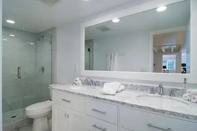 a bathroom with a sink and a toilet and a mirror at 180 Walnut Lower in Carlsbad