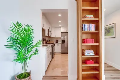 a kitchen with white cabinets and a potted plant at Oceanview Suite Hilltop in San Diego