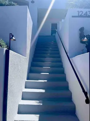 a staircase leading up to a house with blue steps at Oceanview Suite Hilltop in San Diego