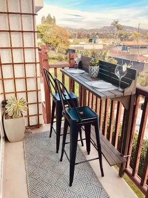 a porch with a table and chairs on a balcony at 2003 Costa Del Mar Road - Unit 678 in Carlsbad