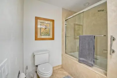 a bathroom with a toilet and a glass shower at 2003 Costa Del Mar Road - Unit 678 in Carlsbad