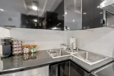 a kitchen with two sinks and a counter top at 2003 Costa Del Mar Road - Unit 678 in Carlsbad