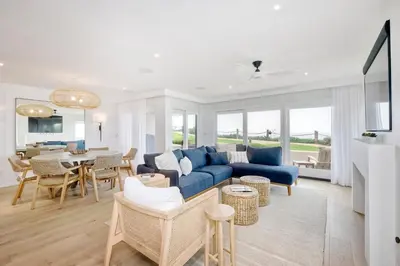 a living room with a blue couch and a table at 597 S Sierra Avenue - Unit 69 in Solana Beach