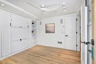 an empty room with white cabinets and a ceiling fan at 597 S Sierra Avenue - Unit 69 in Solana Beach