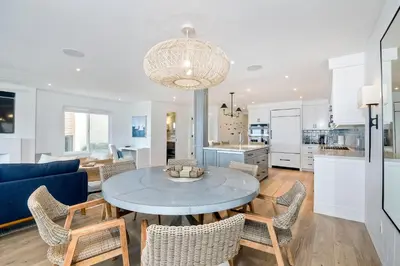 a kitchen and living room with a table and chairs at 597 S Sierra Avenue - Unit 69 in Solana Beach