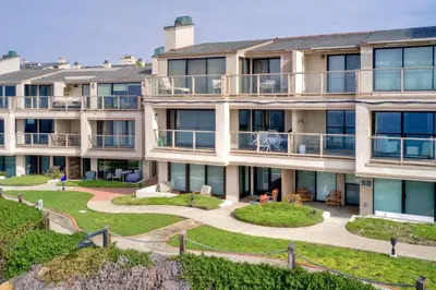 an apartment building with balconies and a yard at 597 S Sierra Avenue - Unit 69 in Solana Beach