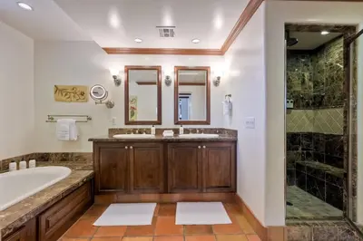 a bathroom with a tub and a sink and a shower at 7323 Estrella Del Mar Unit 6537 in Carlsbad