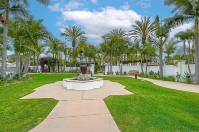 a fountain in a park with palm trees at 7323 Estrella Del Mar Unit 6537 in Carlsbad