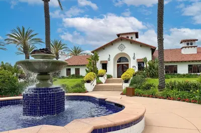 a house with a fountain in front of a house at 7323 Estrella Del Mar Unit 6537 in Carlsbad